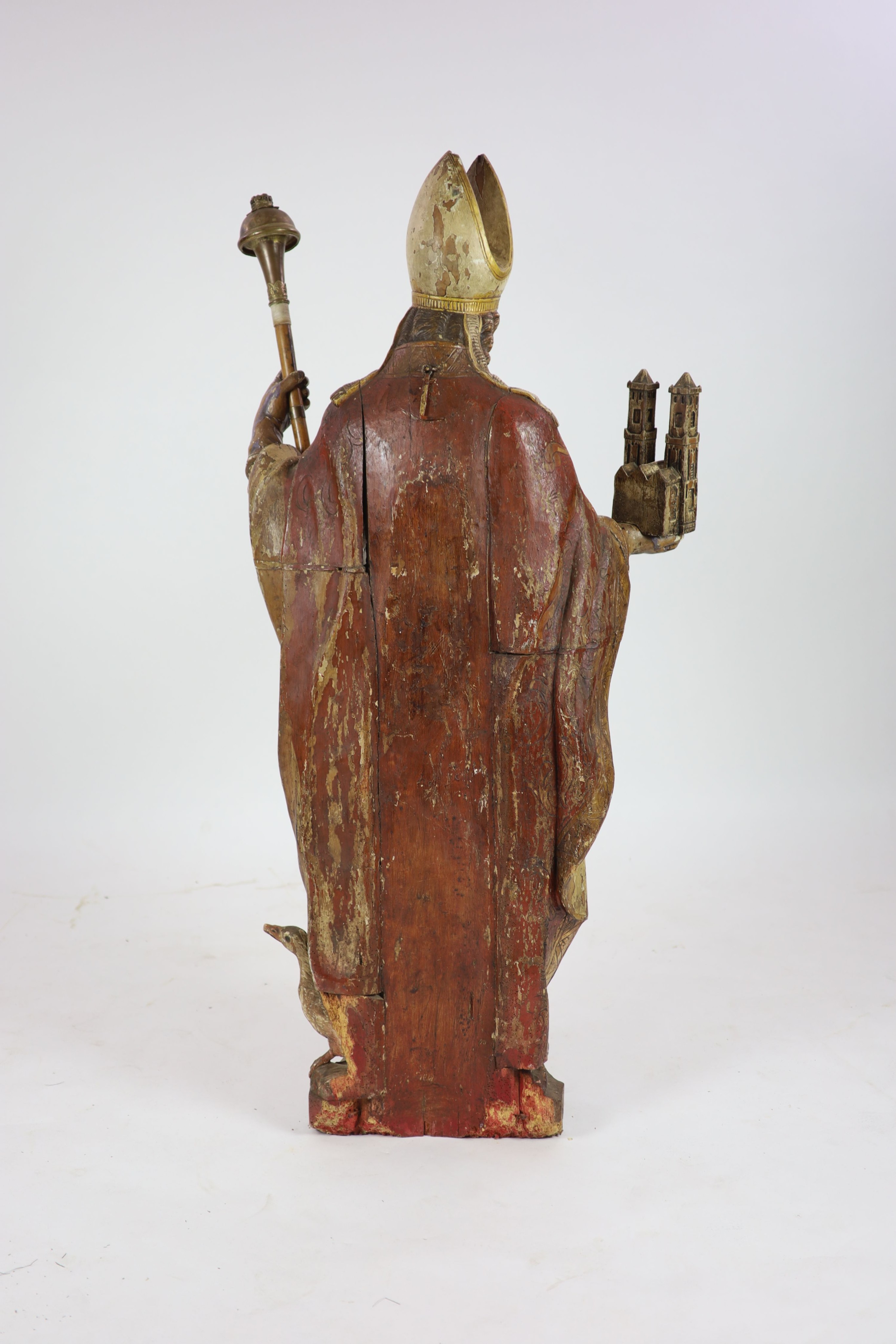 A 19th century German painted carved wood figure of St Ludgerus (b.742) H 157cm.